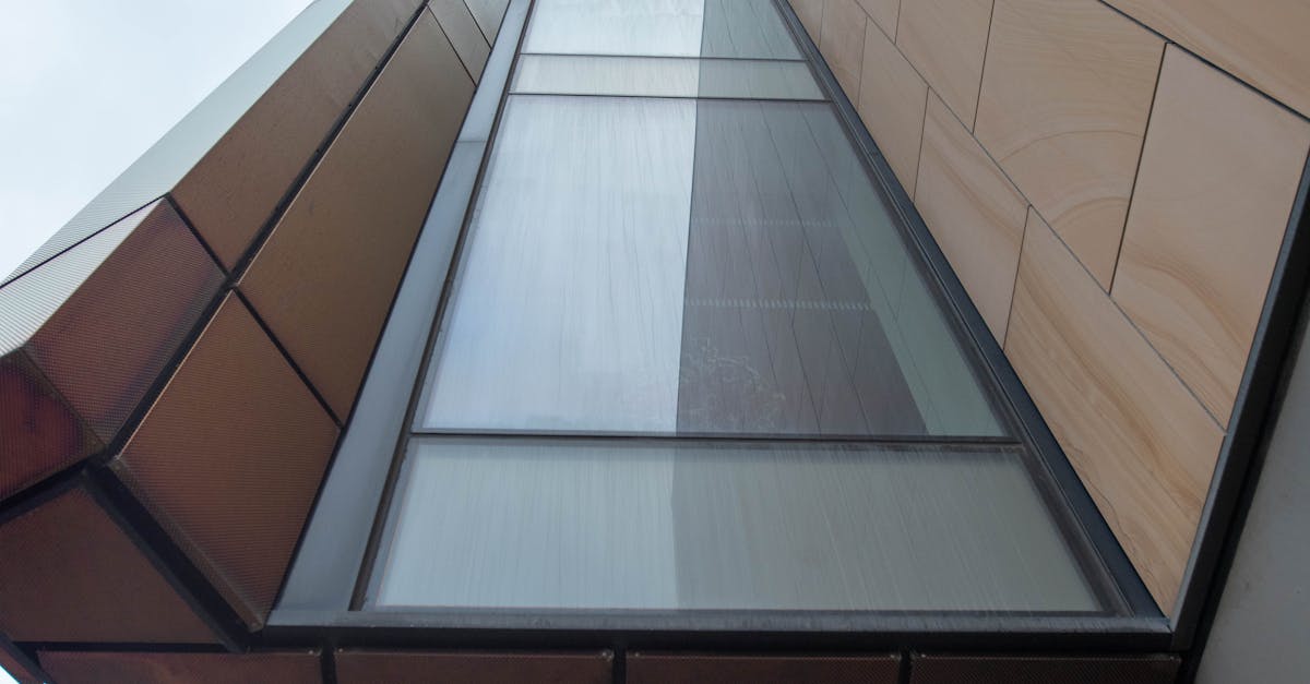 A striking view of contemporary architecture capturing geometric shapes and glass facade from below.