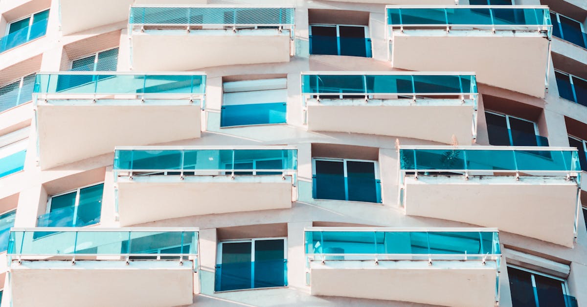 Close-up of a modern building with distinctive glass balconies and geometric design.