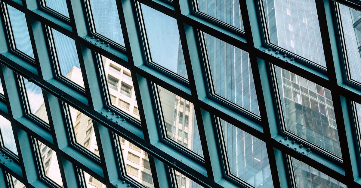 Geometric glass reflections of Seattle's skyline through a modern architectural structure.